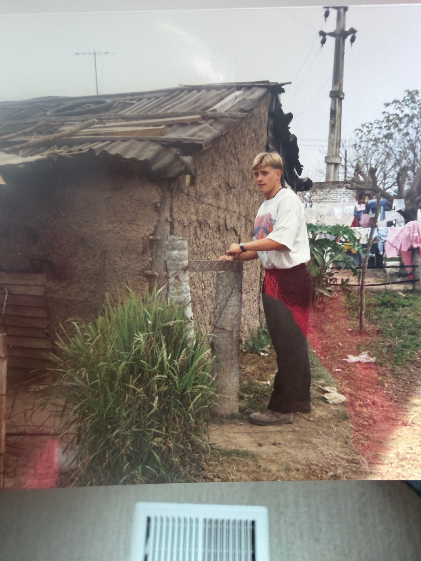 Dave outside an adobe home with corrugated tin roof, Argentina mid-1990s